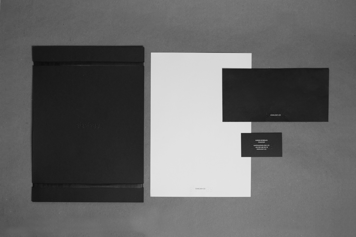 Gigology black-and-white stationery and printed identity system
