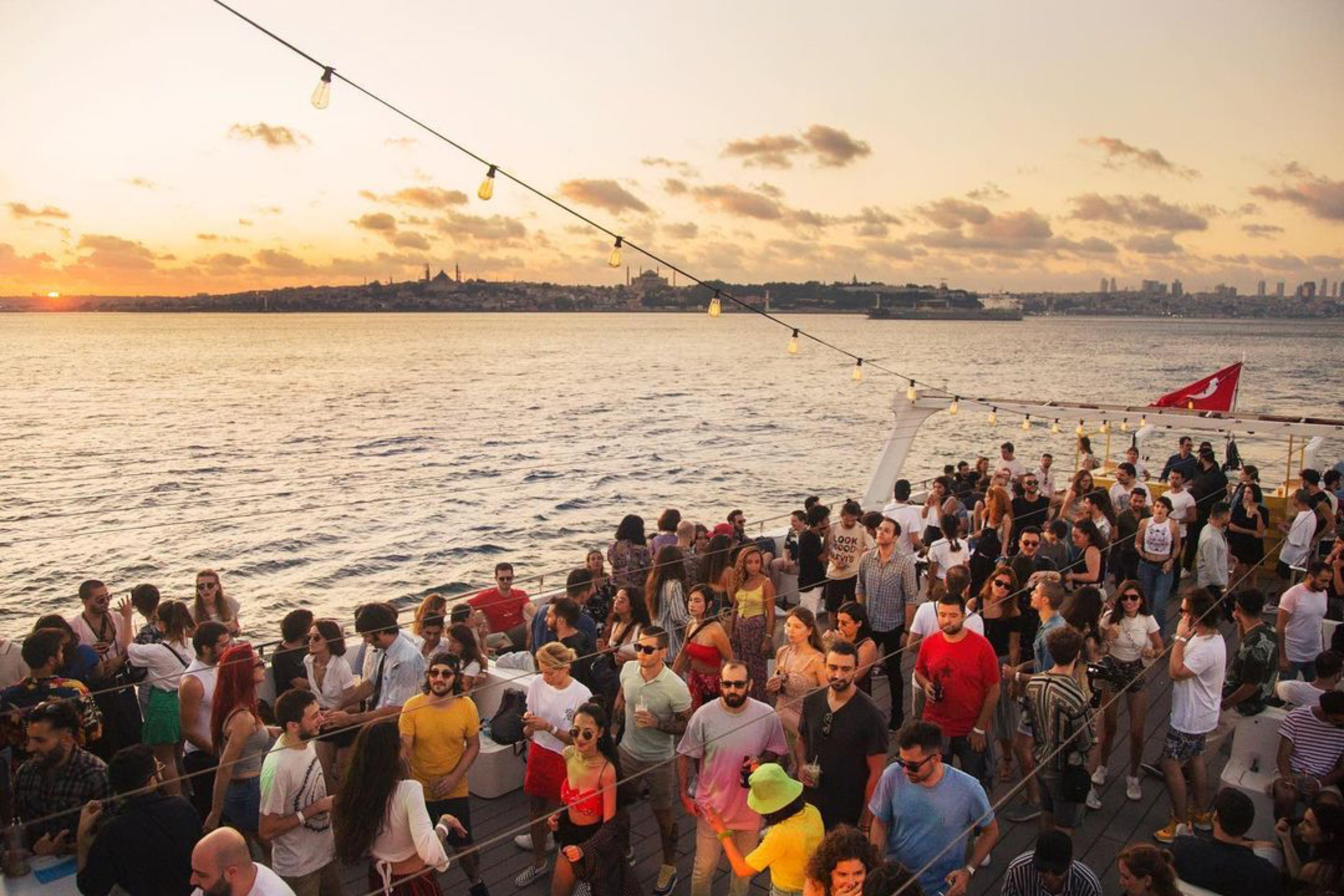 Onboard audience crossing the Bosphorus at sunset
